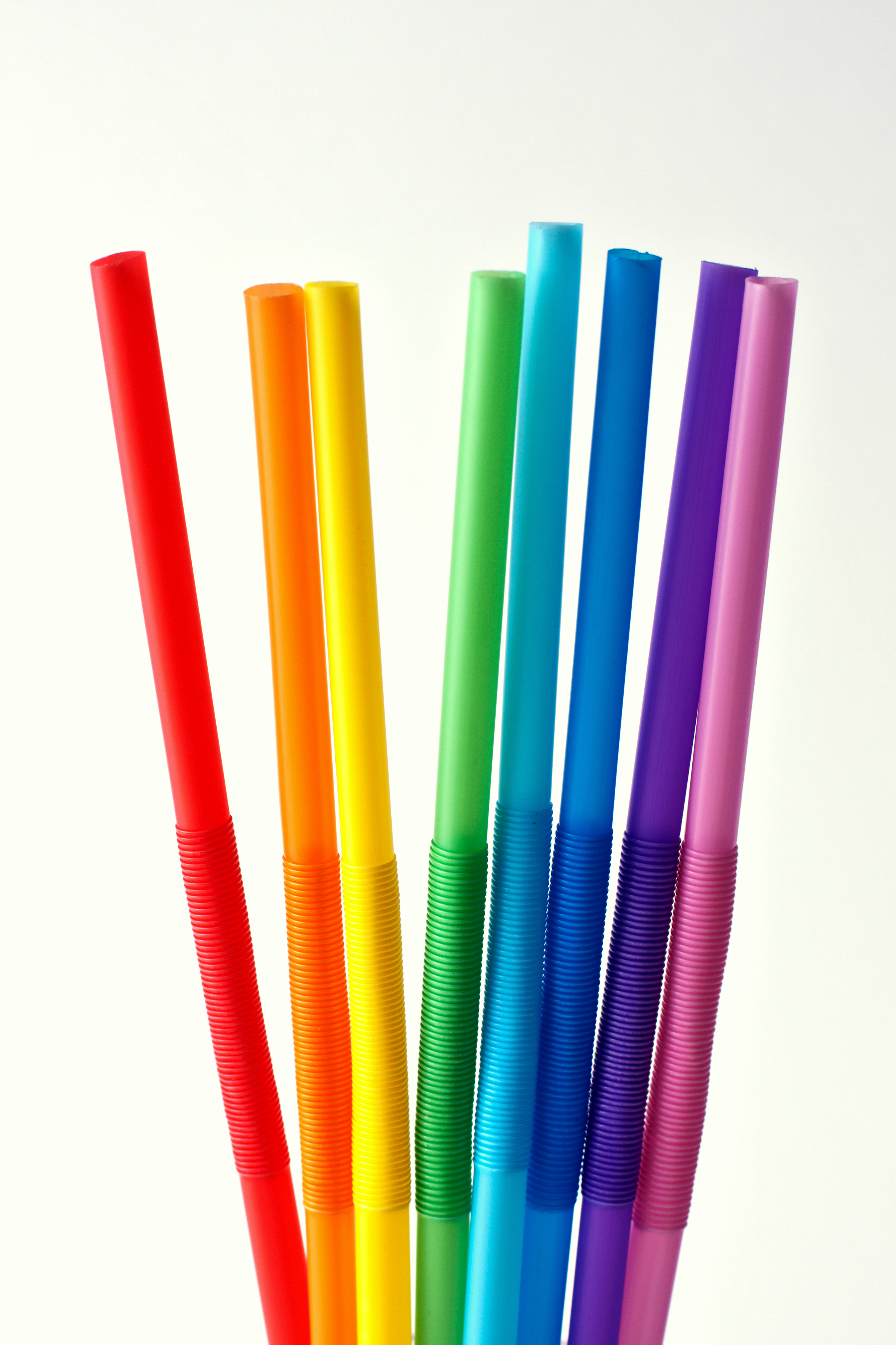 Eight drinking straws in rainbow colors